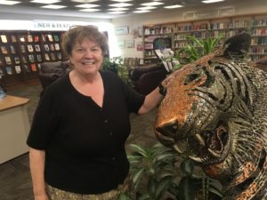 Janet McKenney with tiger sculpture at the Maine State Library